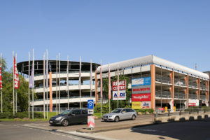 Auf der Ausfahrt vor dem Parkhaus des Seidnitz Centers fahren zwei PKW. Der Himmel ist wolkenlos und blau. Auf der Ausfahrt vor dem Parkhaus des Seidnitz Centers fahren zwei PKW. Der Himmel ist wolkenlos und blau.